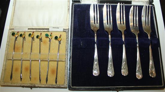 Six silver and enamel cocktails sticks and silver forks